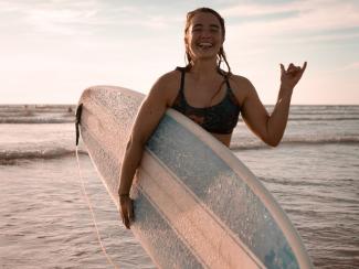 Surfer smiling for a photo having left the water